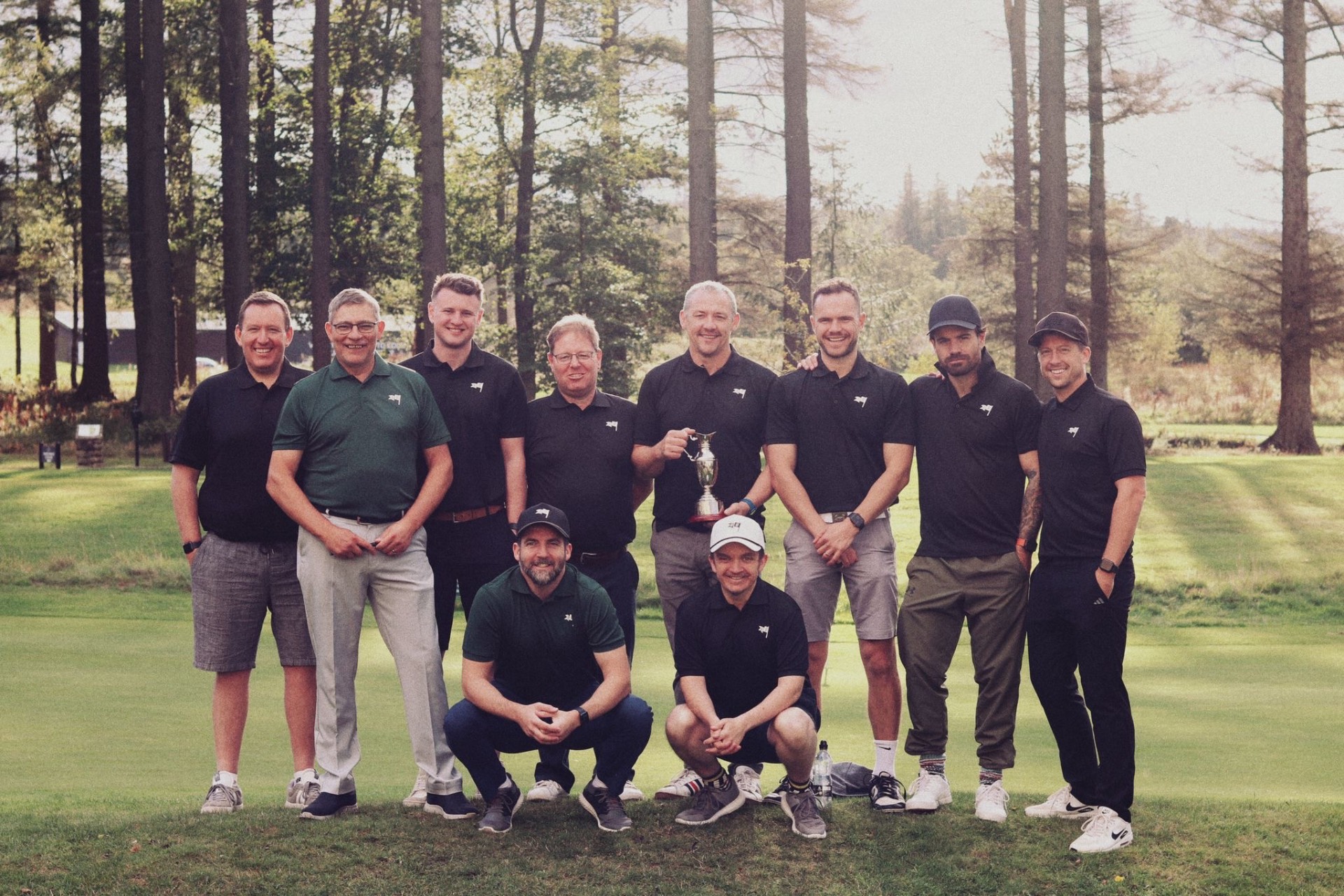 Jimmy's Jug society lineup with the trophy on the green